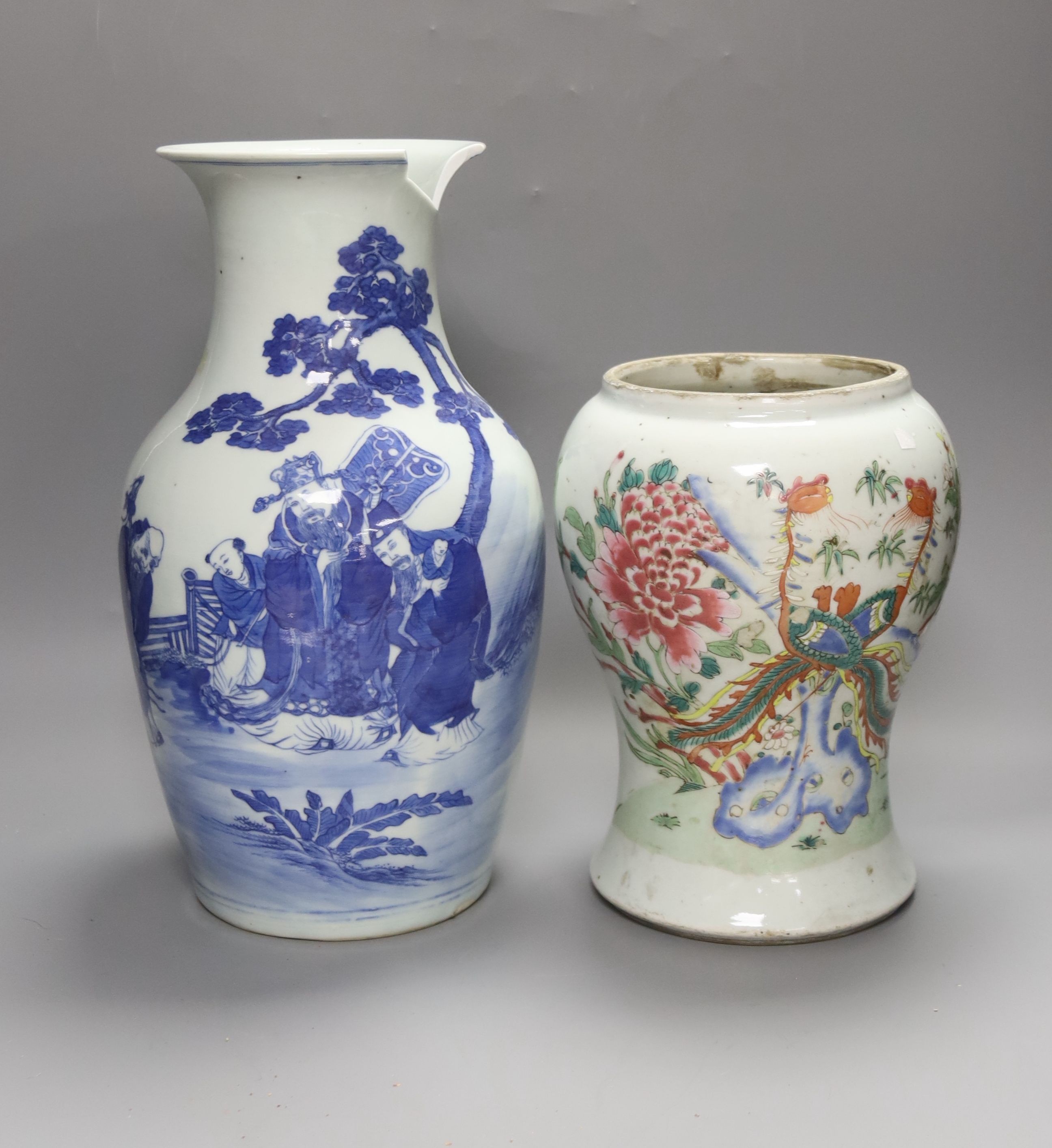 A Chinese blue and white 'Immortals' vase, 18th/19th century, damage, 34.5cm and a Chinese Yongzheng period famille rose ‘phoenix’ vase (reduced in height), 24cm